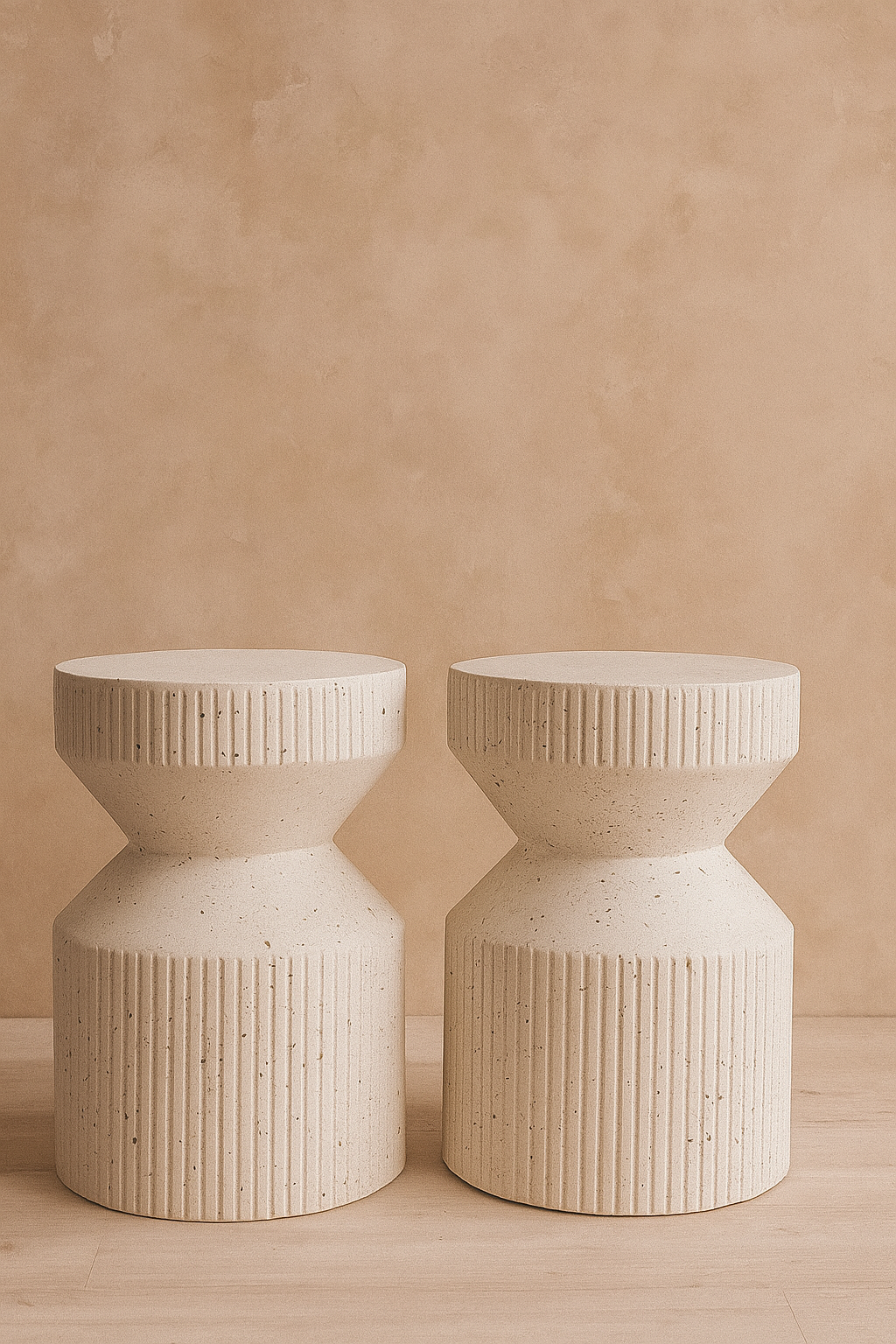 Modern sculptural stools crafted with a textured stone finish, blending minimalist design with timeless durability.
