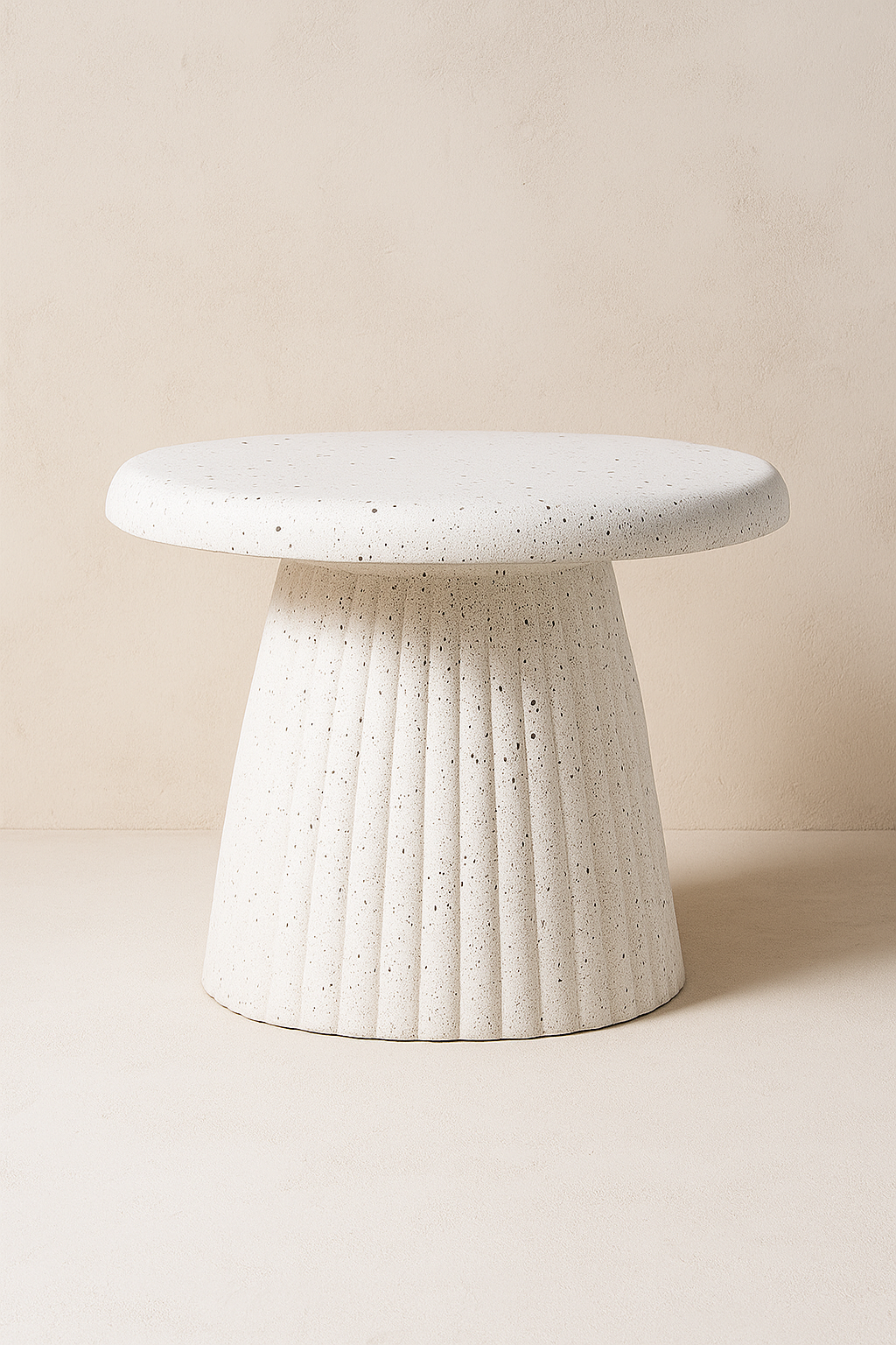 Modern sculptural side table crafted with a textured concrete finish. Featuring a sleek round top and fluted base, this statement piece blends durability with contemporary design. Dimensions: